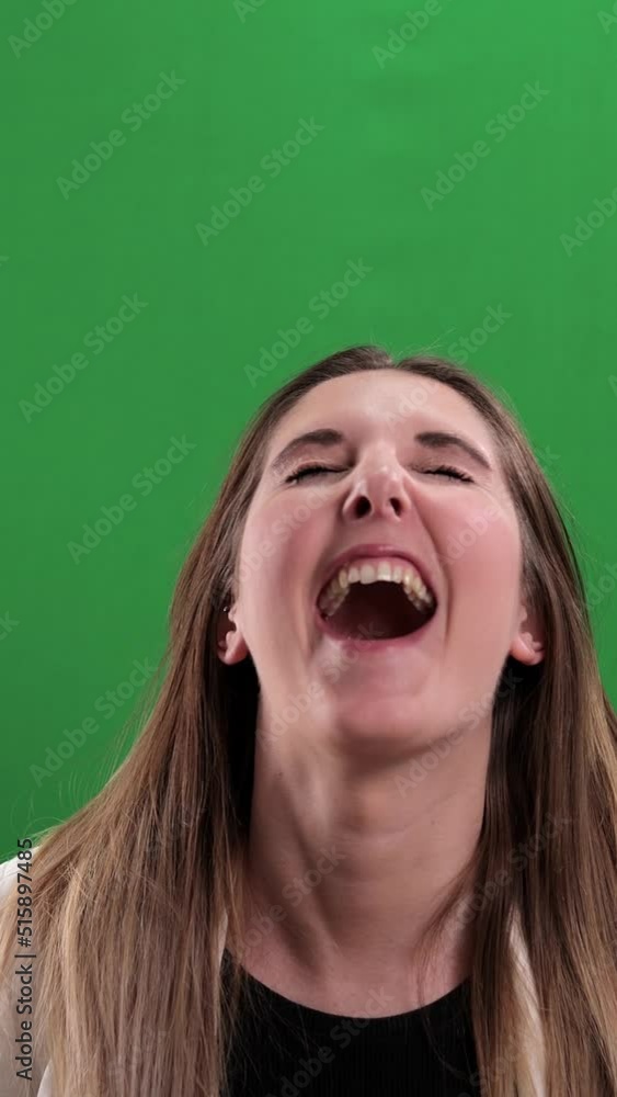 Young woman laughs very loudly - studio photography - Vertical video Young woman laughs very loudly - studio photography - Vertical video