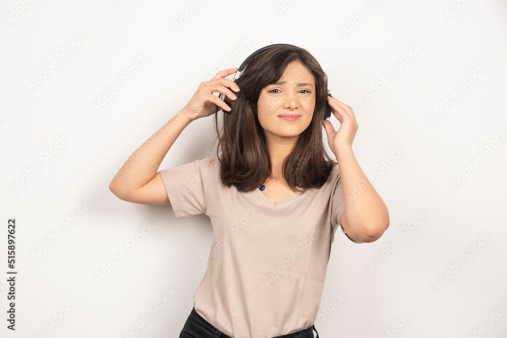 Young woman with headphones on white background Young woman with headphones on white background
