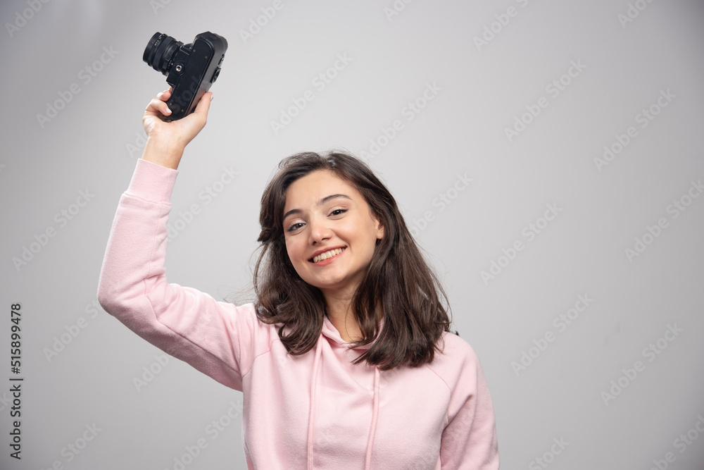 Beautiful woman in pink sweatshirt posing with camera Beautiful woman in pink sweatshirt posing with camera