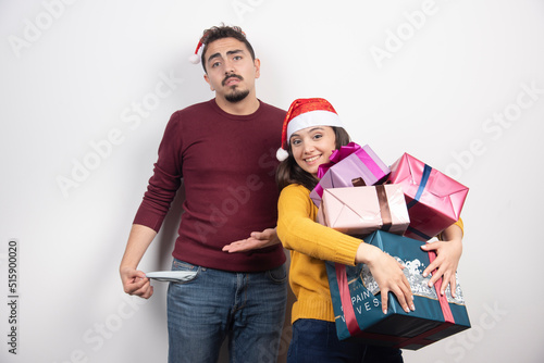 Wallpaper Mural Young woman carrying a lot of Christmas presents Torontodigital.ca