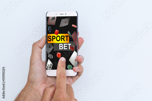 Hand hold a phone with betting online on a screen