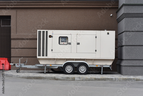 heavy diesel electric generator stand on trailer in yard office building