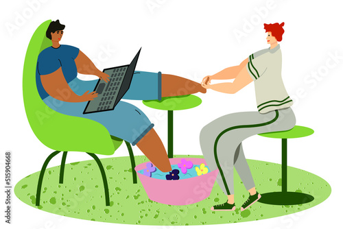 A man working at a computer is getting a pedicure in the salon. Salon employee gives foot massage to client.