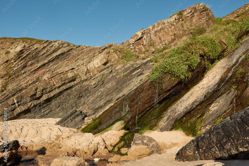 Small waterfall on the Amalia Beach (Praia da Amalia).  Western part of Algarve, Portugal