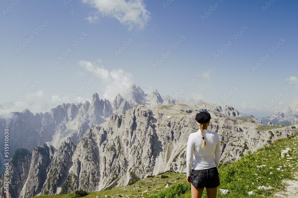 Naklejka premium Woman hiking in the Dolomite mountains