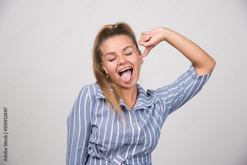 Woman in blue sweater getting tired of noise Woman in blue sweater getting tired of noise