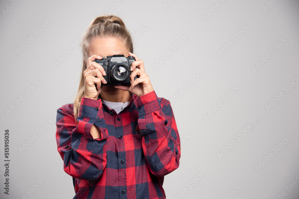 Blonde photograph in checked shirt takes photos as a professional Blonde photograph in checked shirt takes photos as a professional