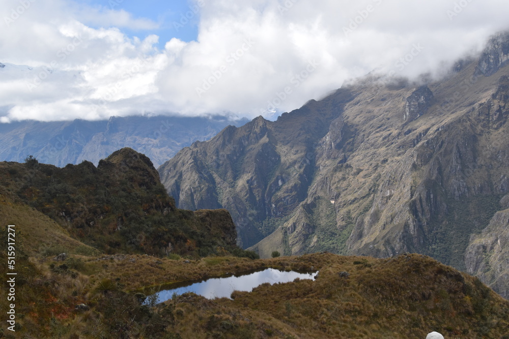 Fototapeta premium Hiking the green valleys and lush jungle and mountain landscape of the Inca Trail in Peru