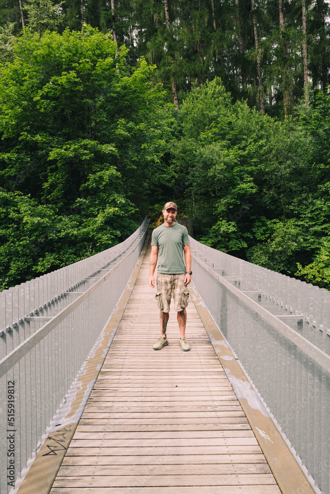 Man standing on the hanging bridge