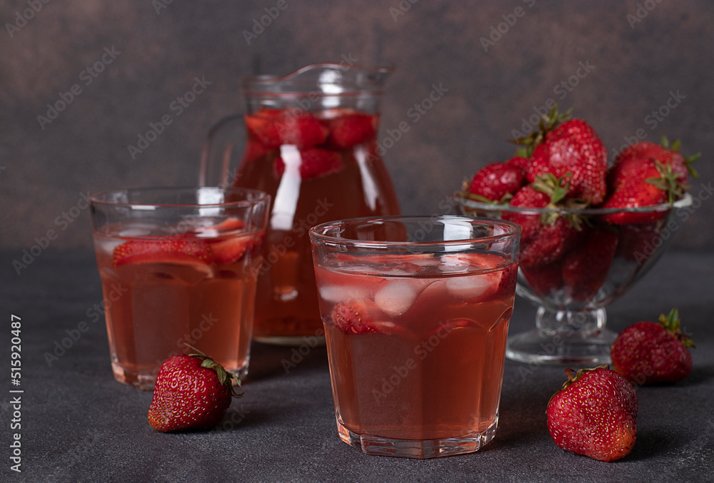 Strawberry Compote in two glasses and jug on brown background Strawberry Compote in two glasses and jug on brown background