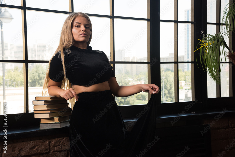 Young woman leaning on books near of window Young woman leaning on books near of window