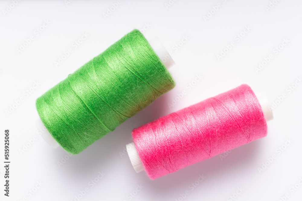 Sewing thread spool on white background, top view. Bobbin with thread Sewing thread spool on white background, top view. Bobbin with thread