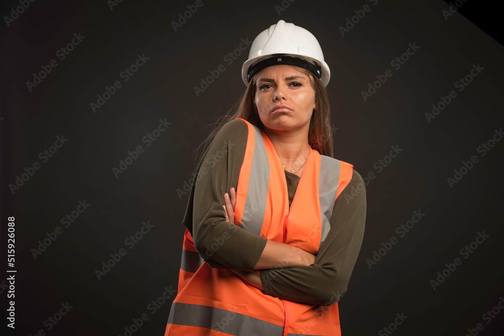 Female engineer wearing a white helmet and gear and looks confident Female engineer wearing a white helmet and gear and looks confident