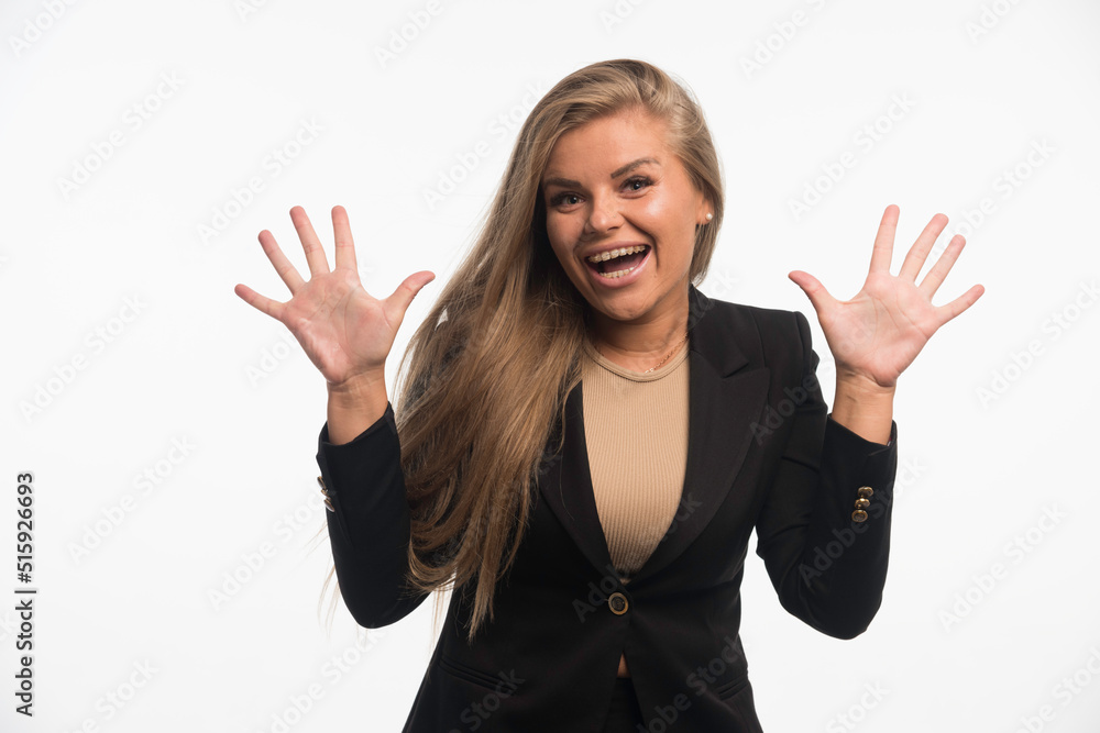 Young businesswoman in black suit looks cheerful Young businesswoman in black suit looks cheerful