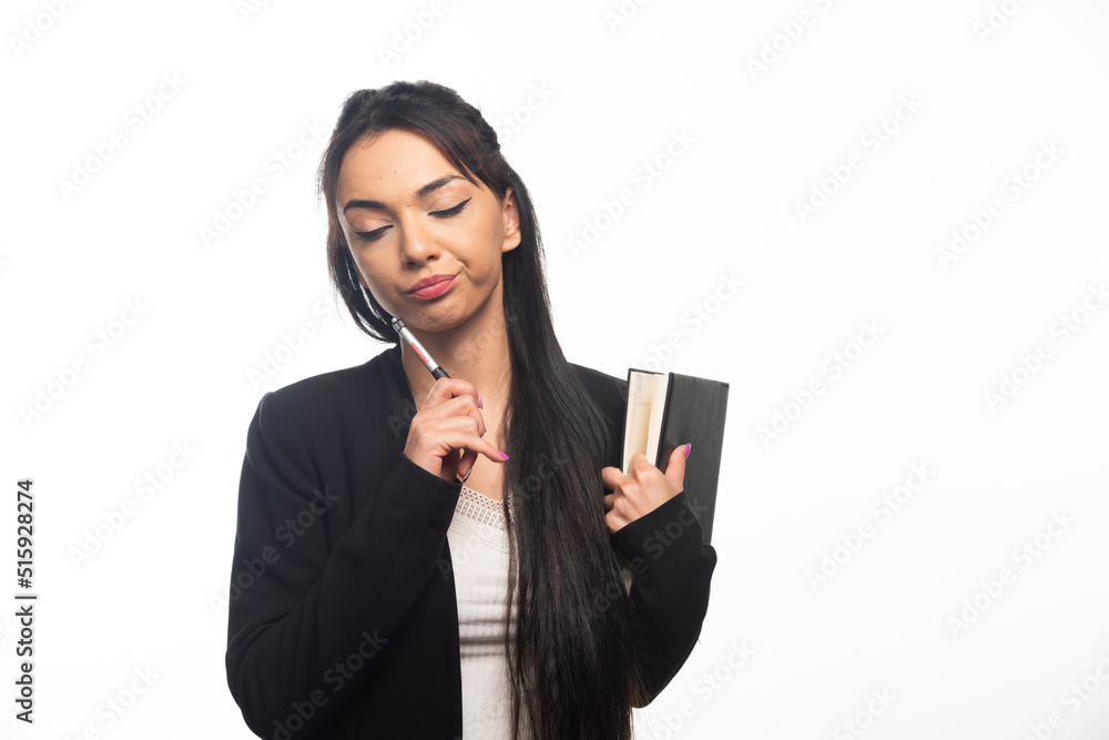 Businesswoman holding a notebook on white background Businesswoman holding a notebook on white background
