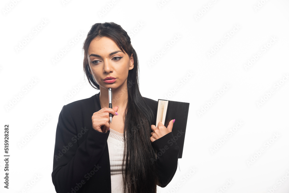Businesswoman holding a notebook on white background Businesswoman holding a notebook on white background
