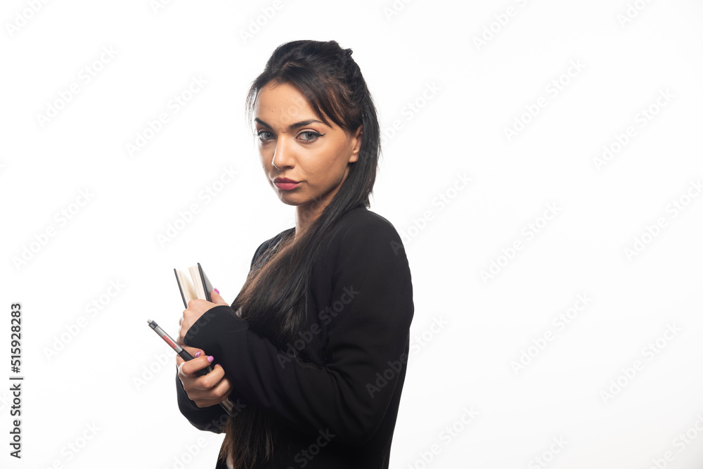 Businesswoman holding a notebook on white background Businesswoman holding a notebook on white background