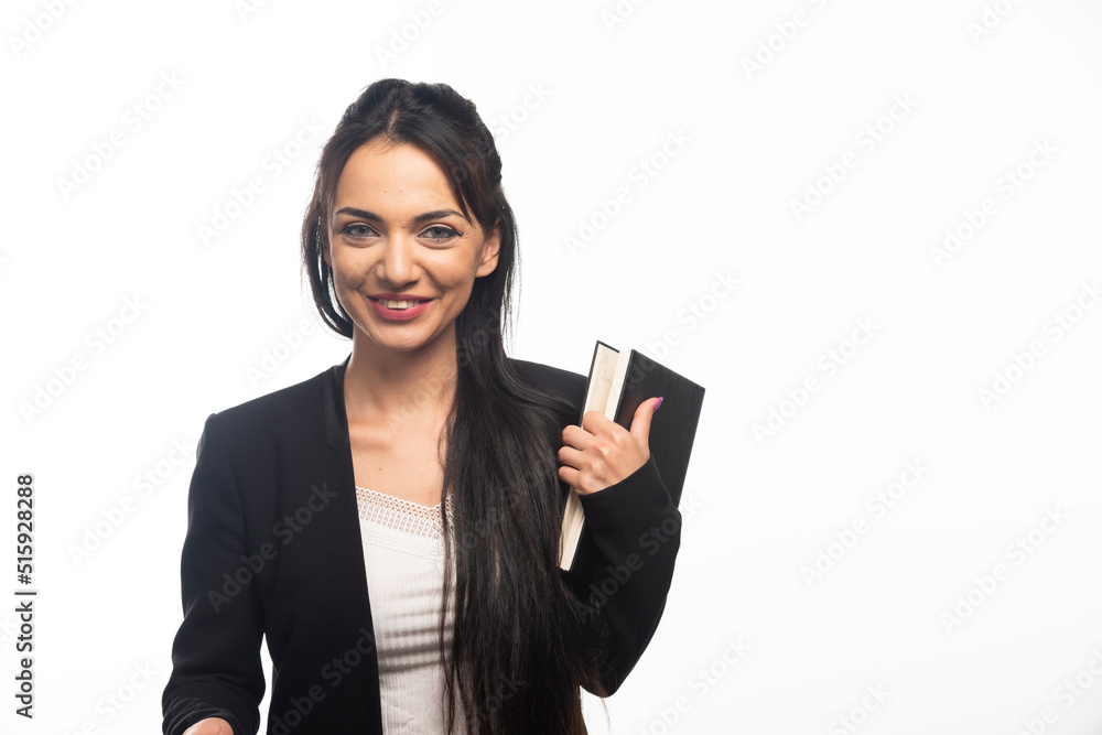 Businesswoman holding a notebook on white background Businesswoman holding a notebook on white background