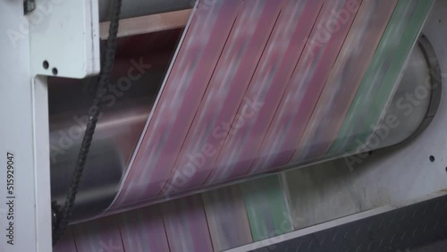 Printing house. Flexo printing. Film spins between shafts. Roller machine prints. Anilox. photo