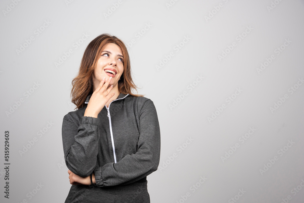 Young smiling woman standing and posing Young smiling woman standing and posing