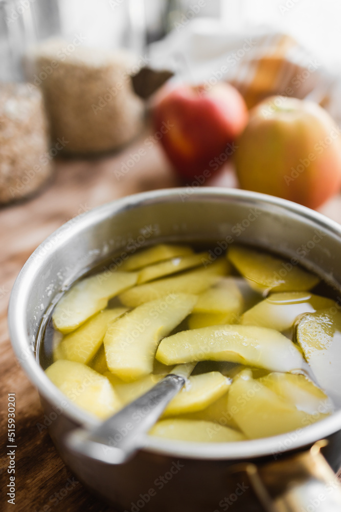 compote of fresh apples in a metal pot in the kitchen (selective focus, blurred background) compote of fresh apples in a metal pot in the kitchen (selective focus, blurred background)