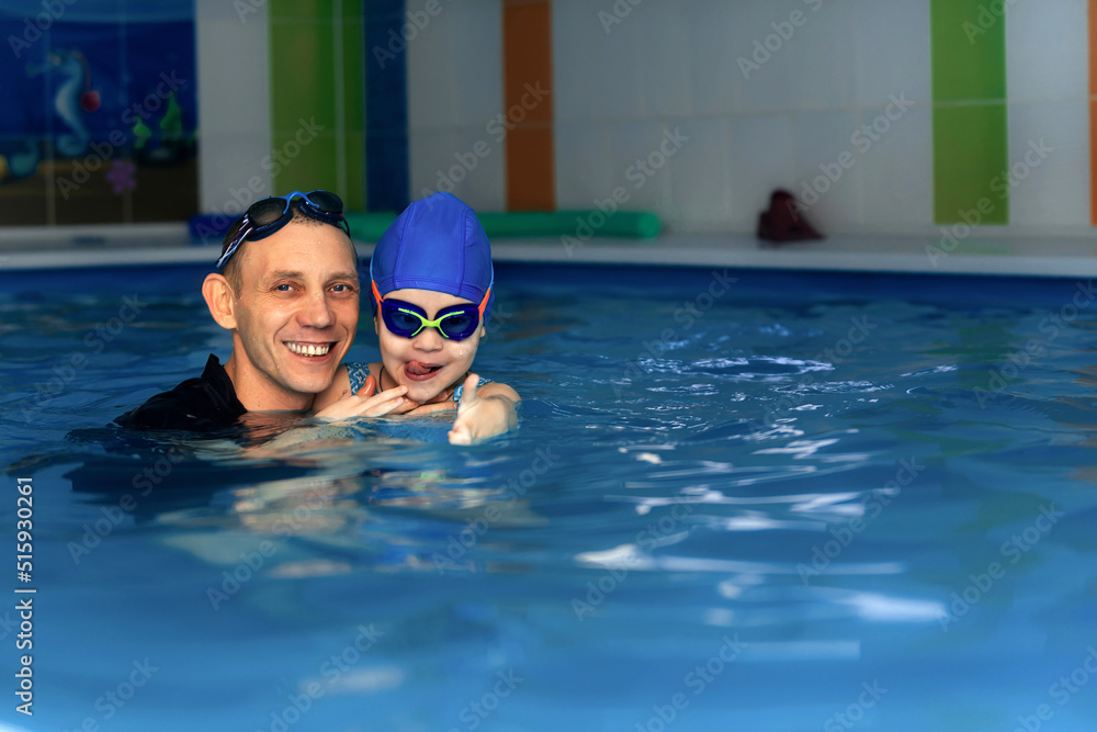 The concept of healthy and sports leisure for children, individual swimming lessons with children in an indoor pool with a coach