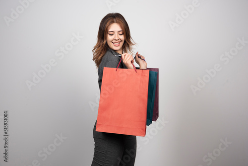 Photo of young woman holding shopping bags