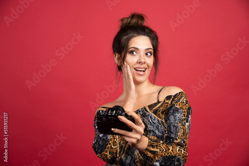 Brunette girl posing in red background