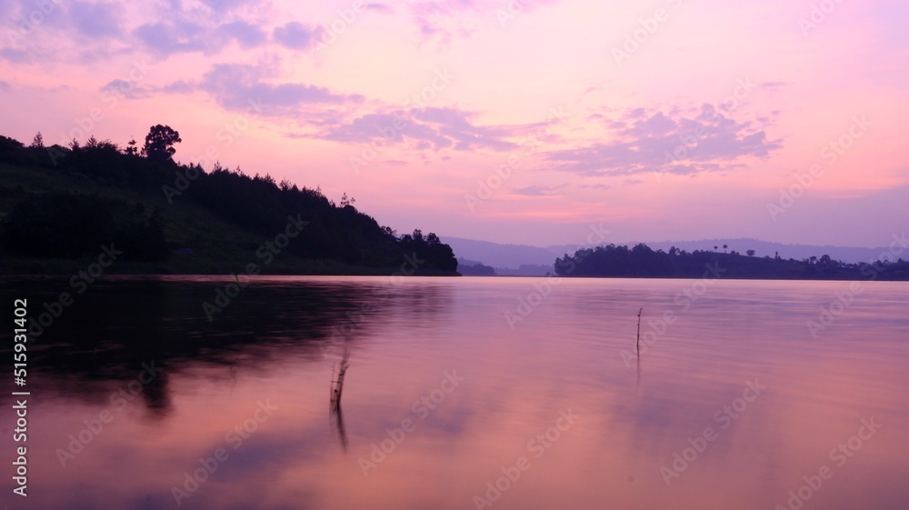 red sunset in the sky in uganda over the lake