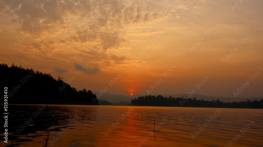 red sunset in the sky in uganda over the lake