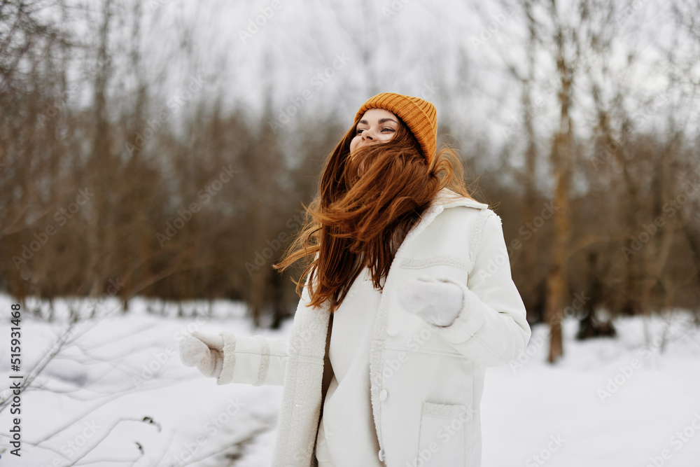 Obraz premium young woman in winter clothes in a hat fun winter landscape winter holidays