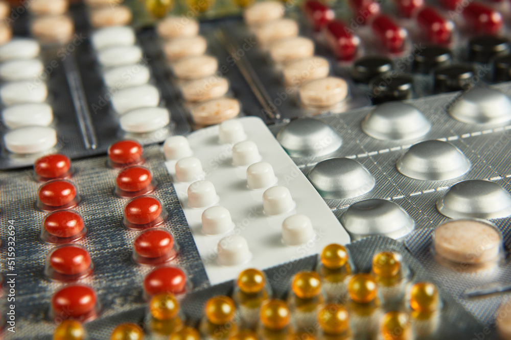 medicines pills multi-colored drugs in packages on a wooden background, close-up, mockup, copy space medicines pills multi-colored drugs in packages on a wooden background, close-up, mockup, copy space