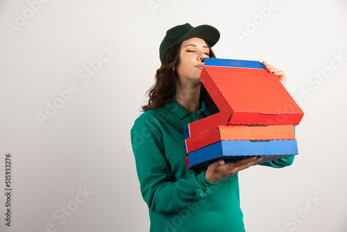 Delivery woman hungrily smelling pizza photo