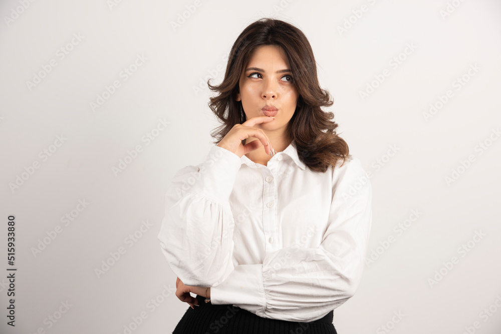 Young employee thinking about job on white background Young employee thinking about job on white background