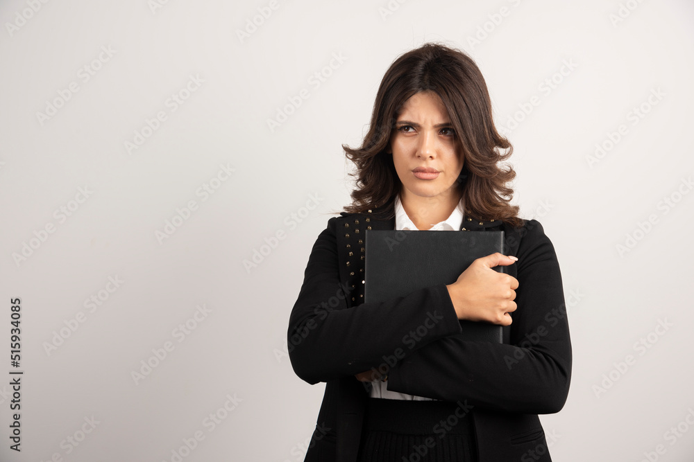 Angry teacher holding book on white background
