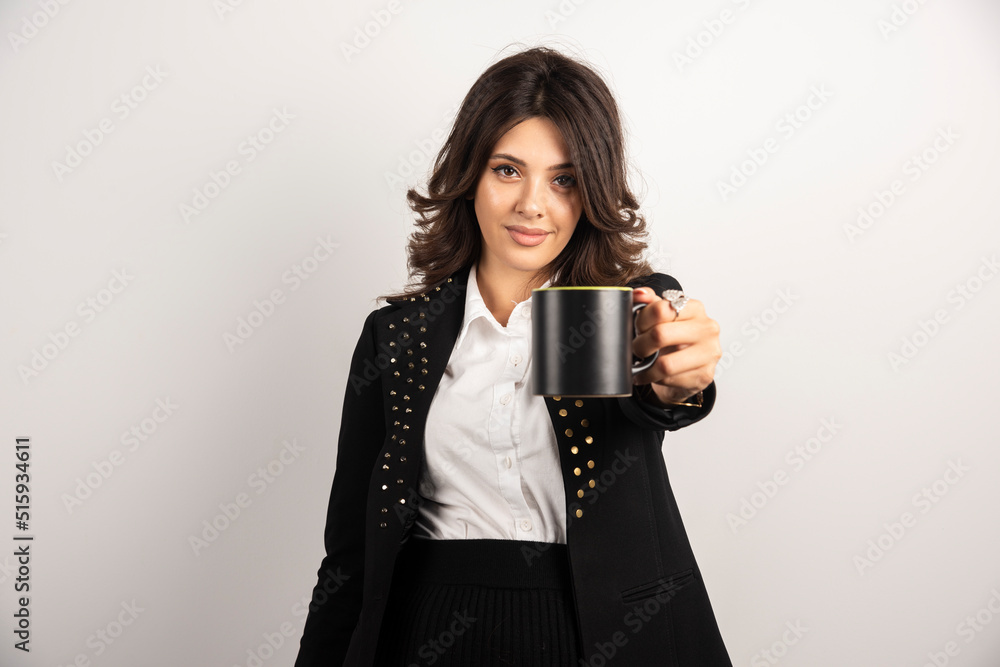 Female office worker offers a cup of tea Female office worker offers a cup of tea