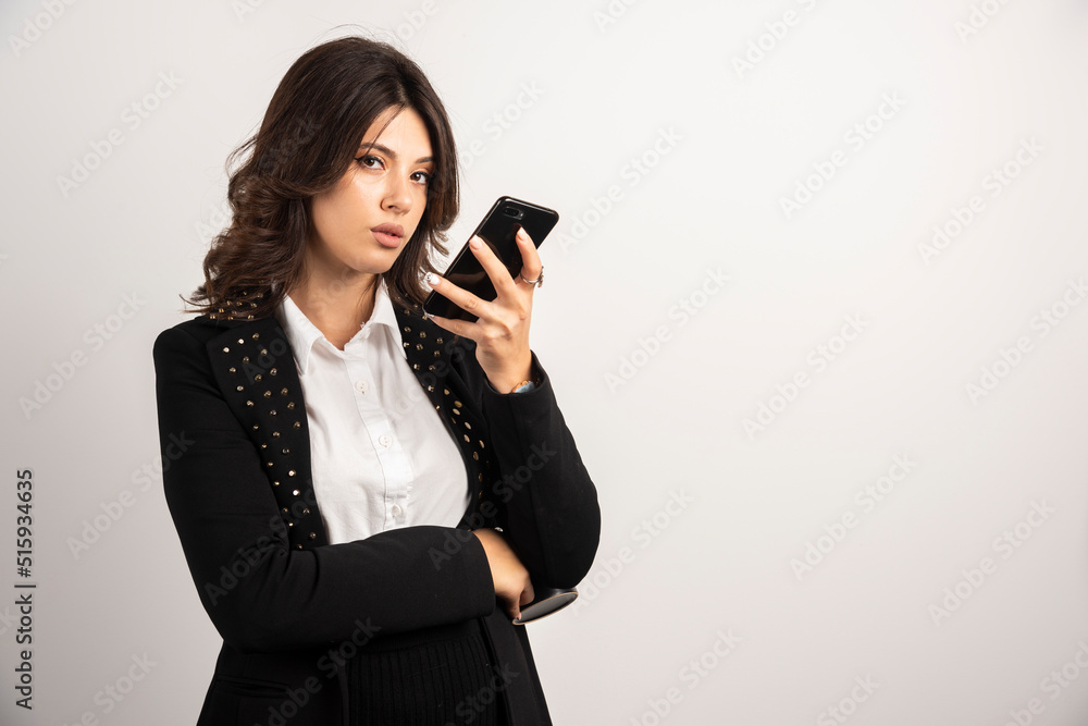 Female employee sending voice message over telephone Female employee sending voice message over telephone