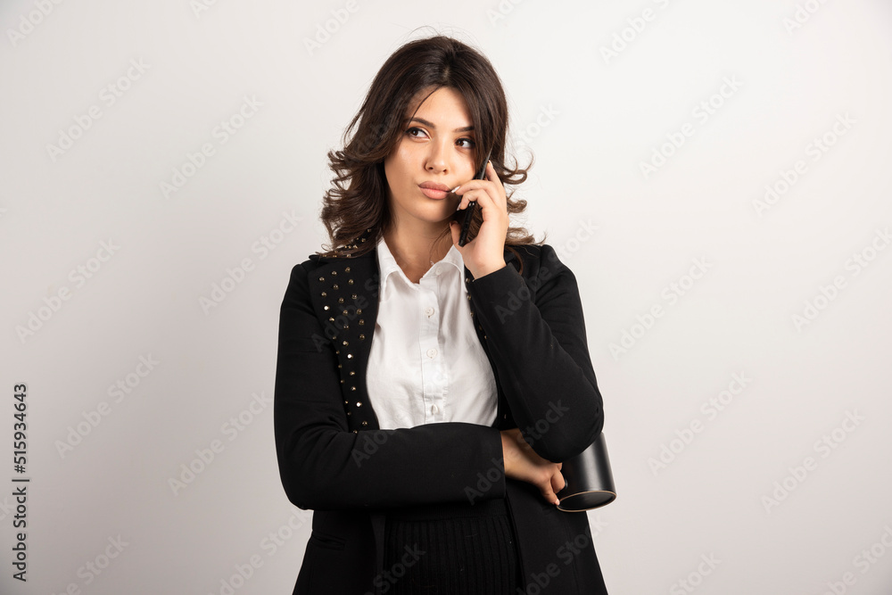 Woman employee talking on telephone on white background Woman employee talking on telephone on white background