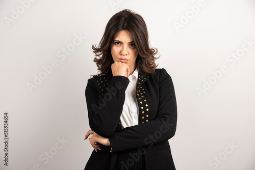 Confident employee standing on white background