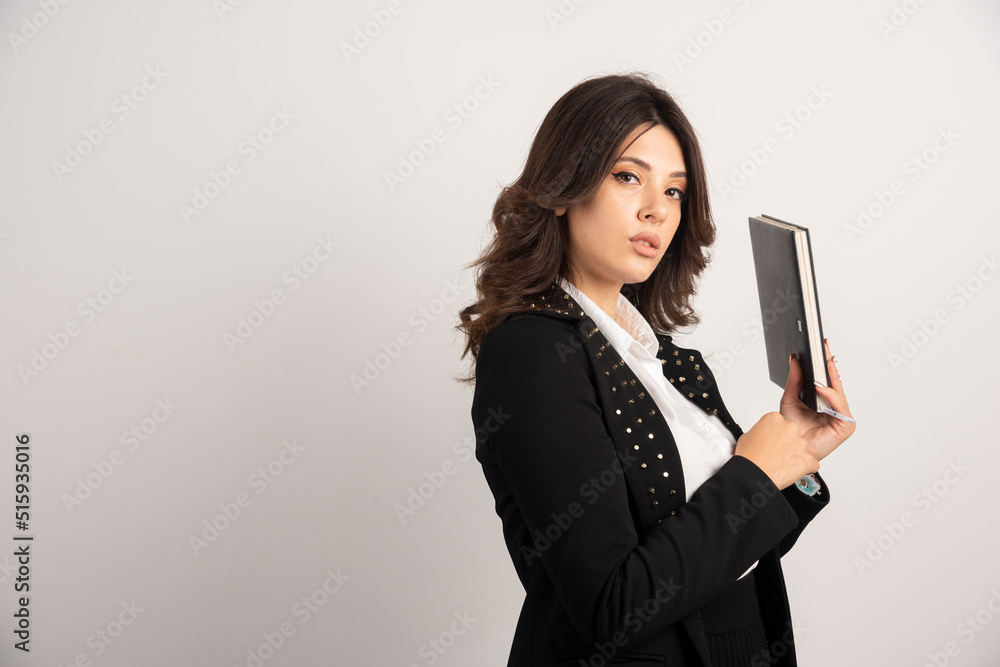 Female teacher posing with book on white background Female teacher posing with book on white background