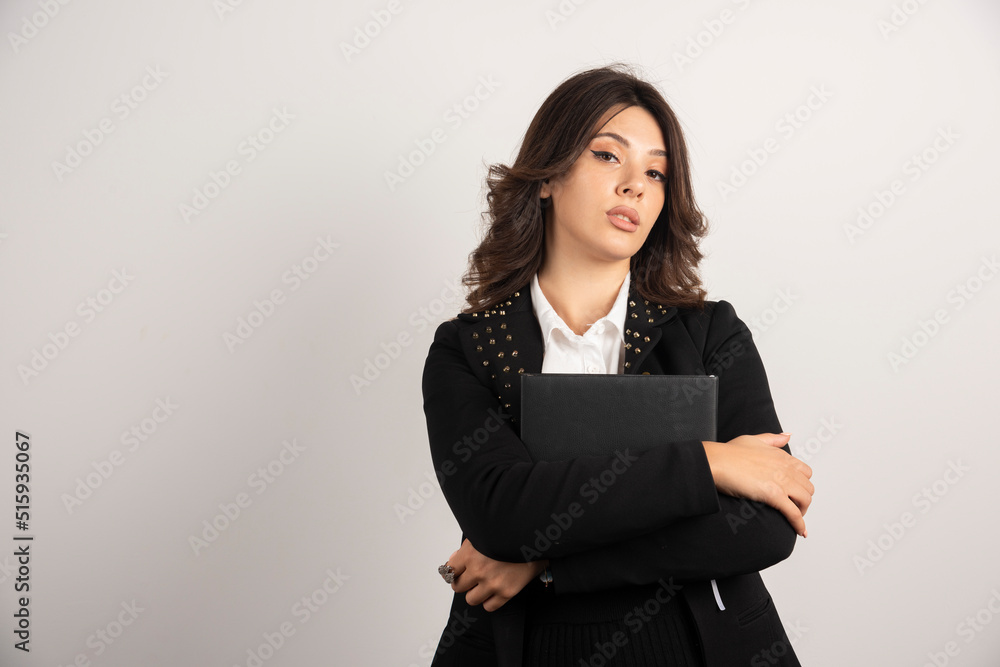 Female teacher posing with book on white background Female teacher posing with book on white background