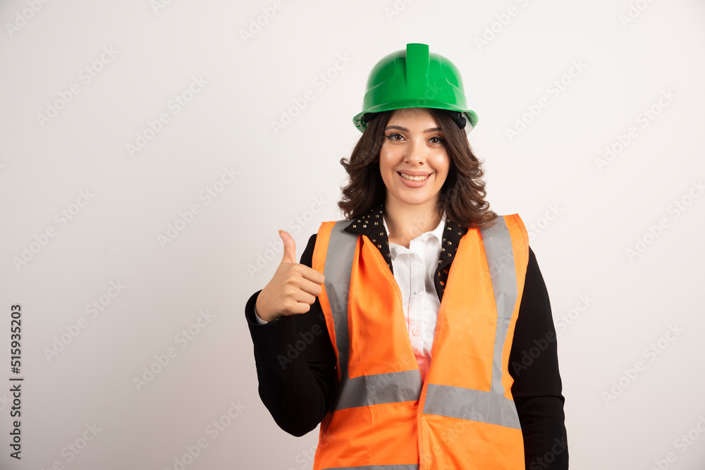 Woman industrial worker showing thumbs up Woman industrial worker showing thumbs up