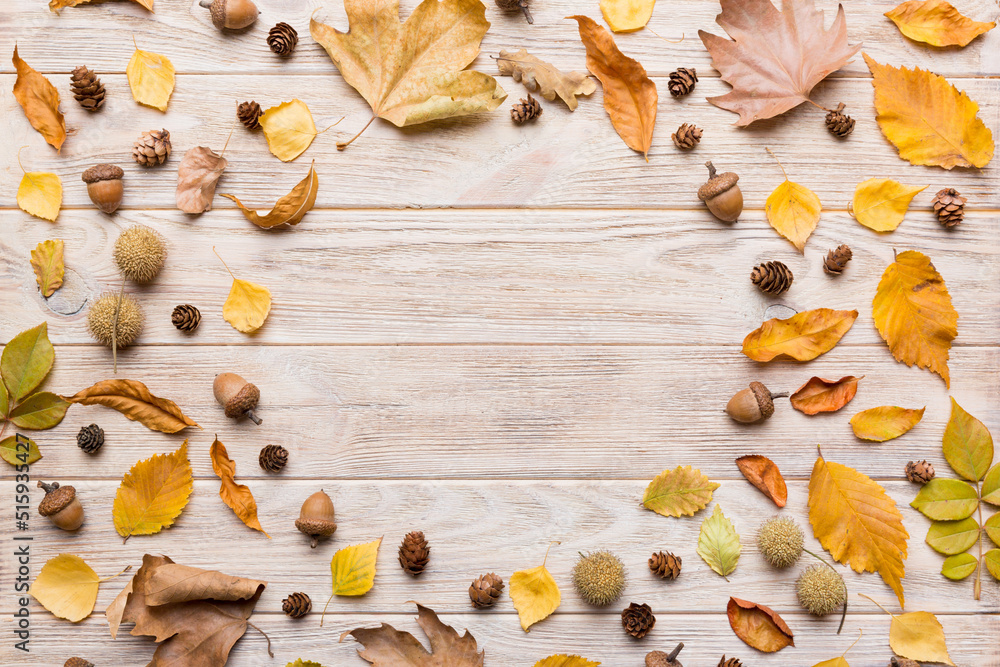 Autumn composition made of dried leaves, cones and acorns on table. Flat lay, top view Autumn composition made of dried leaves, cones and acorns on table. Flat lay, top view