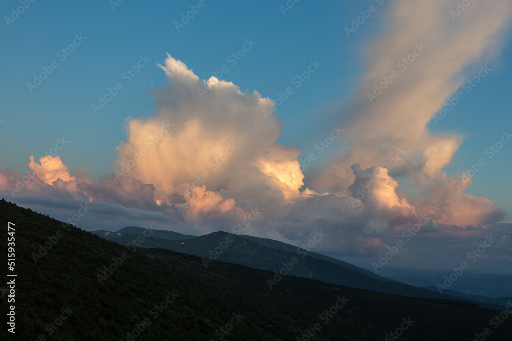 cirro-cumulus and cumulus clouds in the evening light at sunset in the mountains