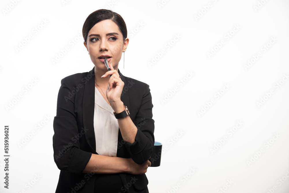 Businesswoman with pencil and cup on white background Businesswoman with pencil and cup on white background