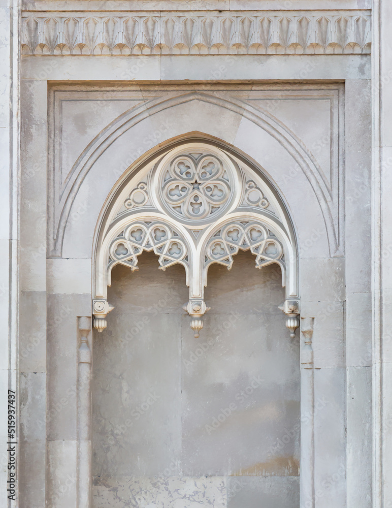 Pertevniyal Valide Sultan Mosque (also known as Aksaray Valide Mosque) in Laleli, Istanbul, Turkey. Ottoman mosque in gothic style. Close up view of marble decorative arch. Art or architecture concept