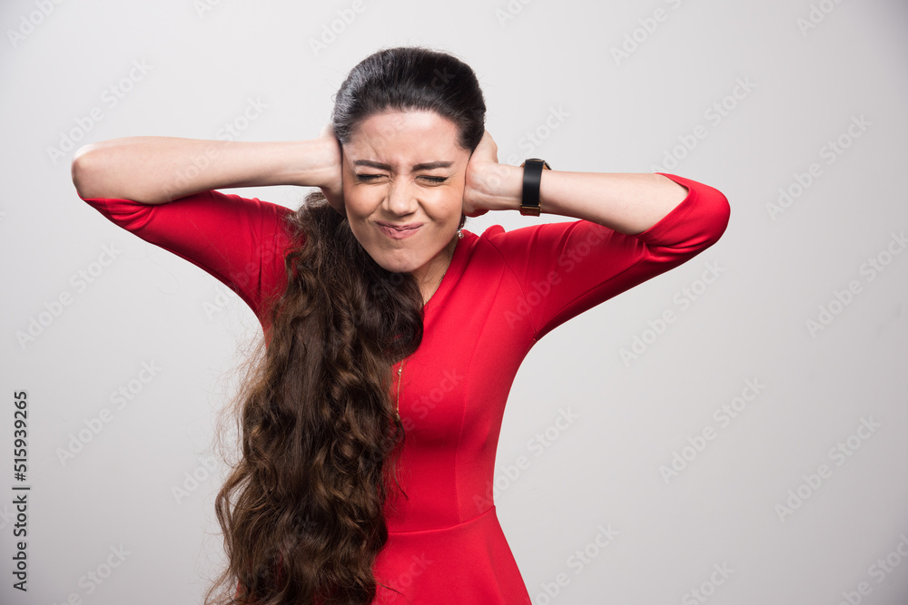 Young Girl closed her hands over her ears Young Girl closed her hands over her ears