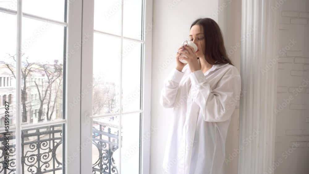 4k Woman relaxing on balcony holding cup of coffee or tea 4k Woman relaxing on balcony holding cup of coffee or tea