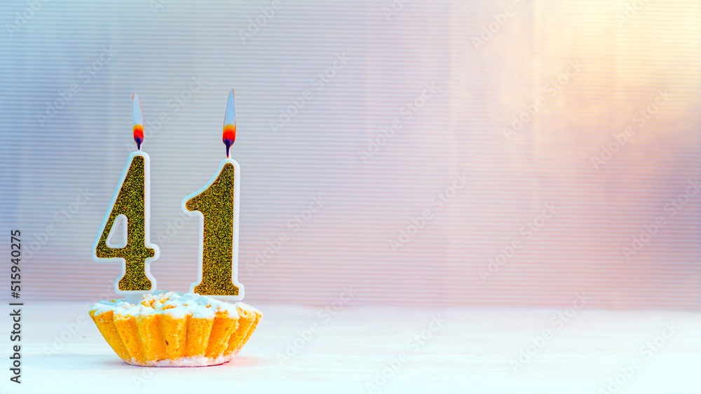 Happy birthday card from candles with the number 41 , golden numbers
