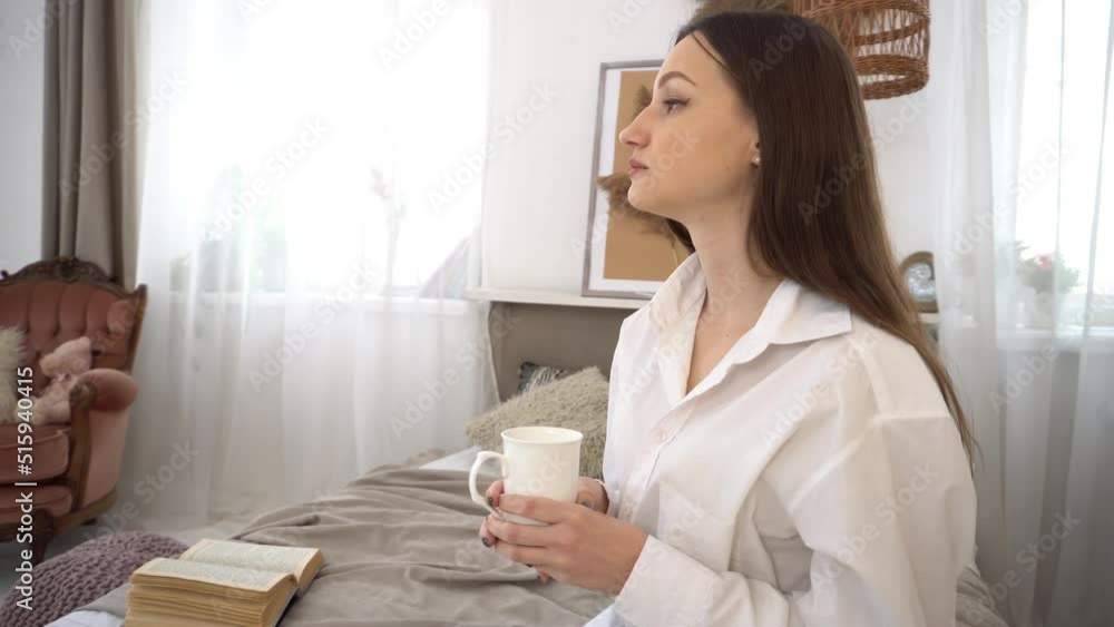 4k A beautiful girl drinking coffee in her bed in the morning. 4k A beautiful girl drinking coffee in her bed in the morning.
